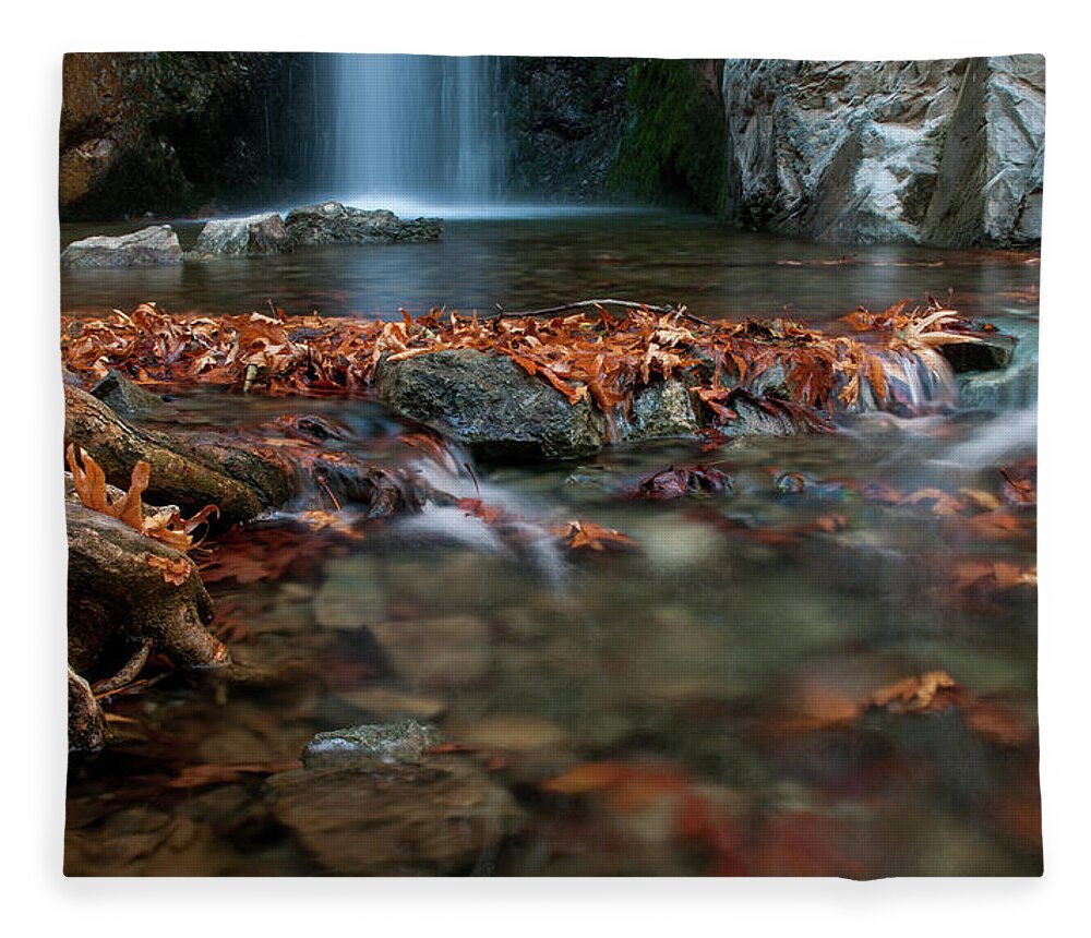 Troodos Fleece Blanket featuring the photograph Waterfall and river flowing with maple leaves on the rocks on the river in Autumn by Michalakis Ppalis