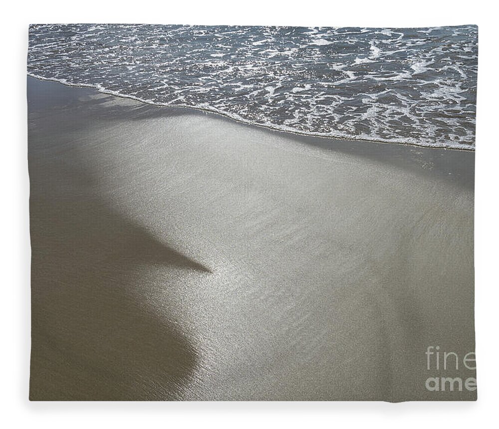 Sandy Beach Fleece Blanket featuring the photograph Wet sand, sea water and reflections of sunlight by Adriana Mueller
