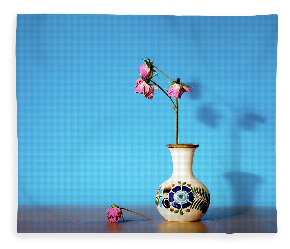 Still Life Fleece Blanket featuring the photograph Wilted roses against blue by Alessandra RC