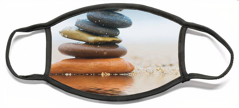 Stone Face Mask featuring the photograph Stack of beach stones on sand #2 by Michal Bednarek