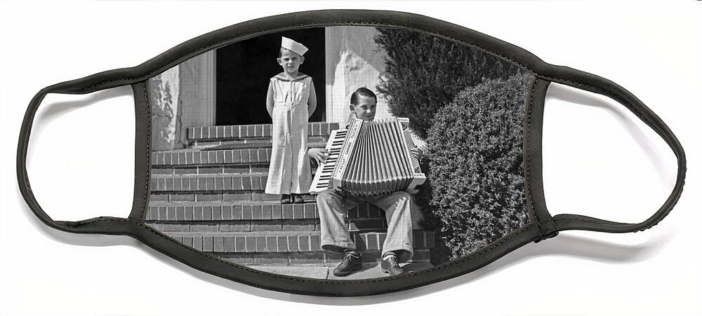 1910s Face Mask featuring the photograph Boy Playing Accordian On Steps by Underwood Archives