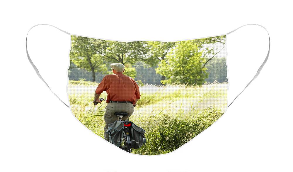 Old Face Mask featuring the photograph Old man on a bike by Patricia Hofmeester