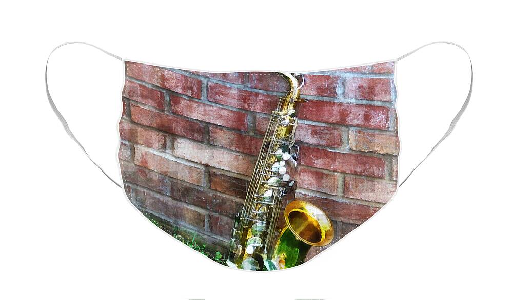 Saxophone Face Mask featuring the photograph Saxophone Against Brick by Susan Savad