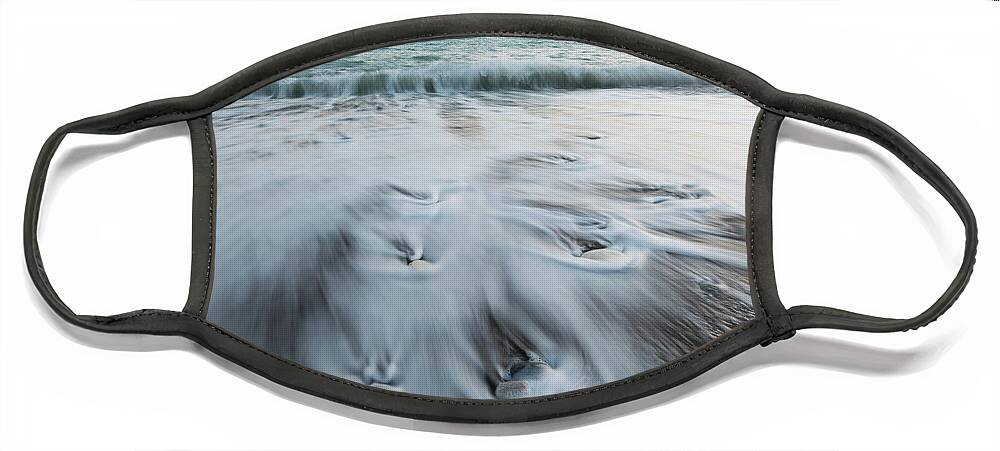 Coastline Face Mask featuring the photograph Pebbles in the beach and flowing sea water by Michalakis Ppalis
