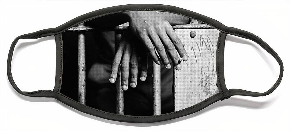 1970s Face Mask featuring the photograph African American Hands Through Bars by H. Armstrong Roberts/ClassicStock