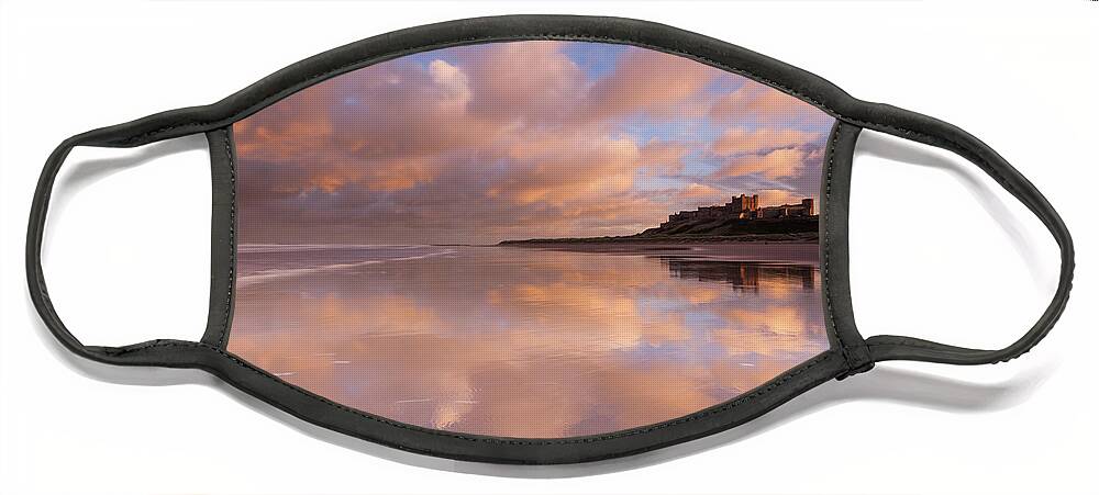 Bamburgh Castle Face Mask featuring the photograph Bamburgh Castle sunset reflections on the beach by Anita Nicholson