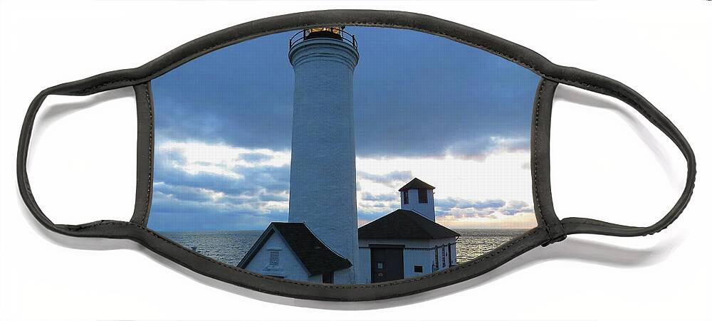 The Light At Tibbetts Point Lighthouse Shines With The December Clouds Face Mask featuring the photograph December light, Tibbetts Point by Dennis McCarthy