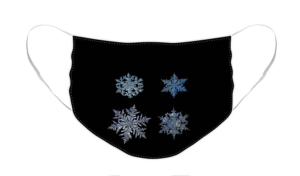 Snowflake Face Mask featuring the photograph Four snowflakes on black background by Alexey Kljatov