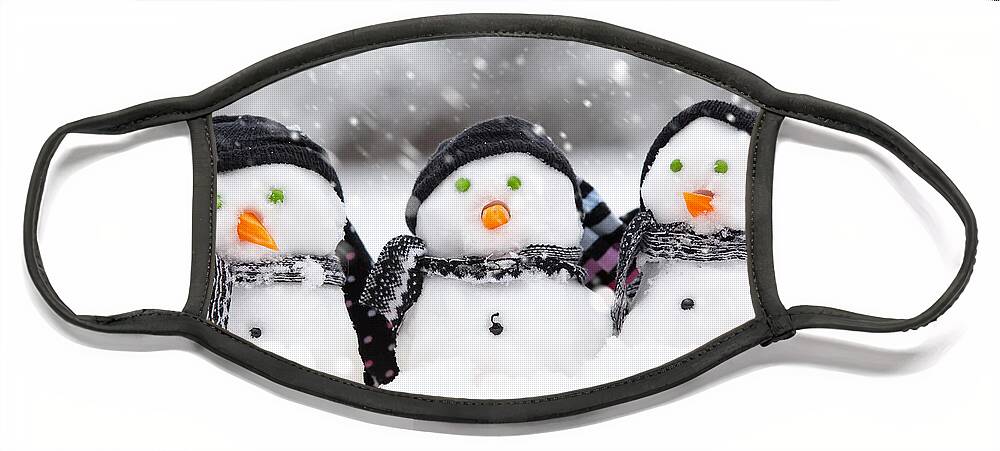 Christmas Face Mask featuring the photograph Three cute snowmen by Simon Bratt