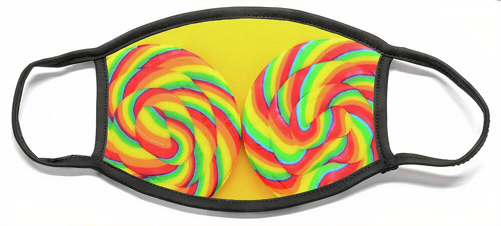 Holiday Face Mask featuring the photograph Rainbow lollipop candy on bright yellow wood table. #3 by Milleflore Images