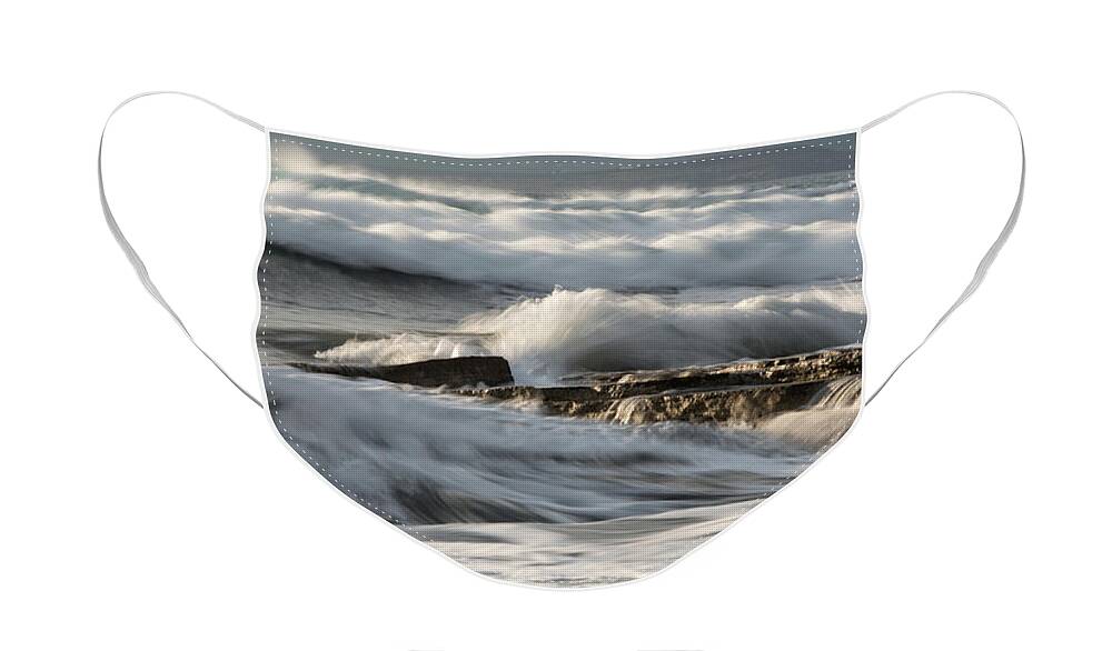 Seascape Face Mask featuring the photograph Rocky seashore with wavy ocean and waves crashing on the rocks #5 by Michalakis Ppalis