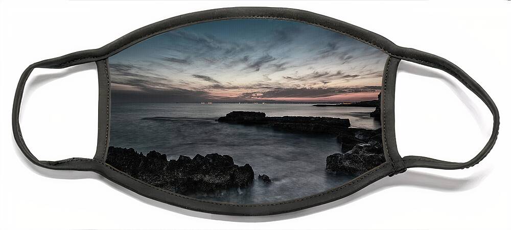 Seascape Face Mask featuring the photograph Beautiful dramatic Sunset on a rocky coastline by Michalakis Ppalis