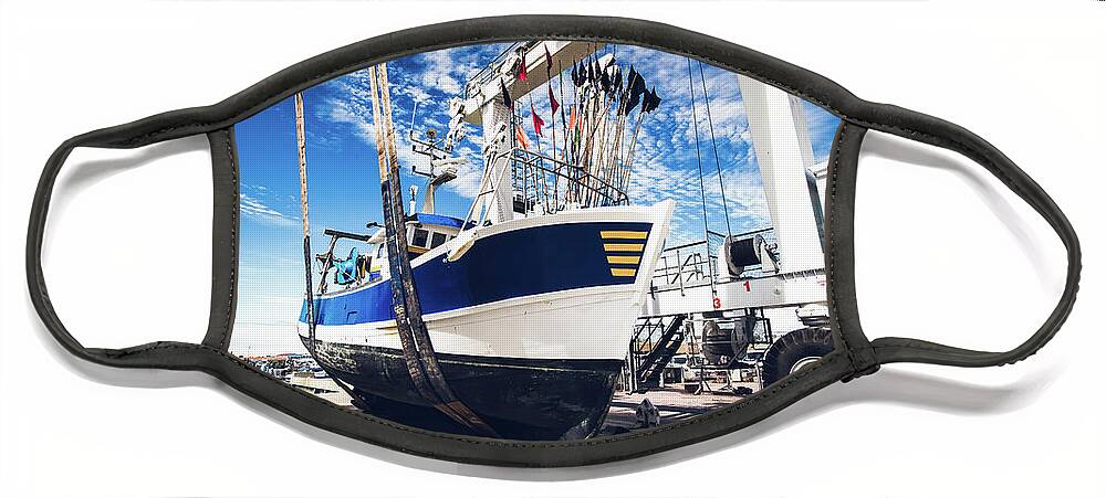 Blue Face Mask featuring the photograph Fishing boat lifted by a boat lift by Jean-Luc Farges