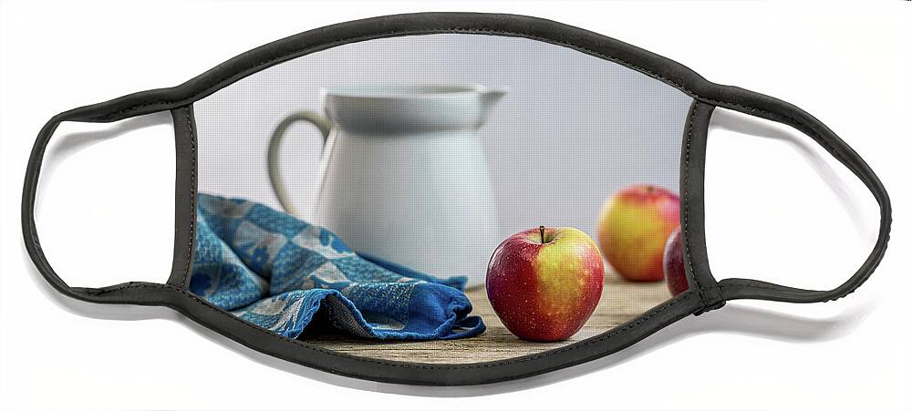 Drinking Glass Face Mask featuring the photograph Fresh apples on a rustic wooden table by Benoit Bruchez