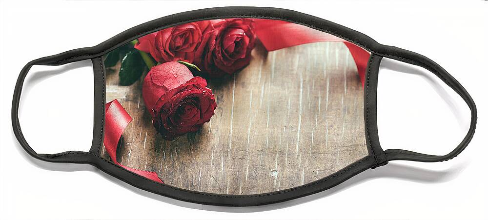 Roses Face Mask featuring the photograph Red roses with red ribbon on wooden table by Jelena Jovanovic