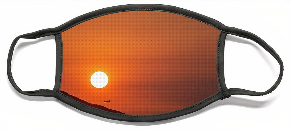 Sunset Face Mask featuring the photograph Red sunset and plane in flight by Hannes Roeckel