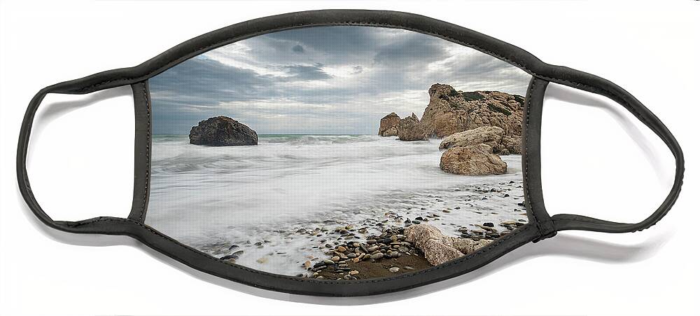 Seascape Face Mask featuring the photograph Seascape with windy waves splashing at the rocky coastal area. by Michalakis Ppalis