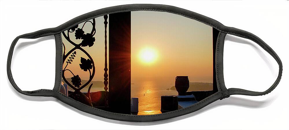Nightfall Face Mask featuring the photograph Sunset in the aegean sea from a house. Santorini island Greece. by Michalakis Ppalis