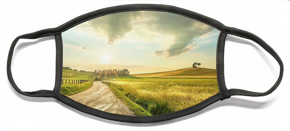 Tuscany Face Mask featuring the photograph Sunset landscape in Alta Maremma. by Stefano Orazzini