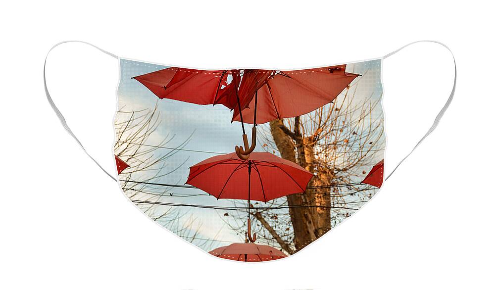 Umbrellas Face Mask featuring the photograph The clash of the umbrellas by Yavor Mihaylov