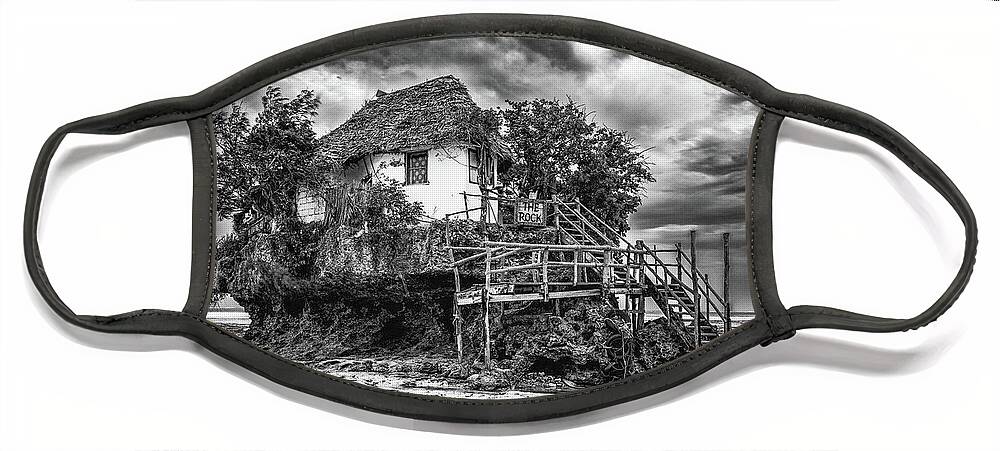 Bungalow Face Mask featuring the photograph The Rock, Zanzibar black and white by Lyl Dil Creations