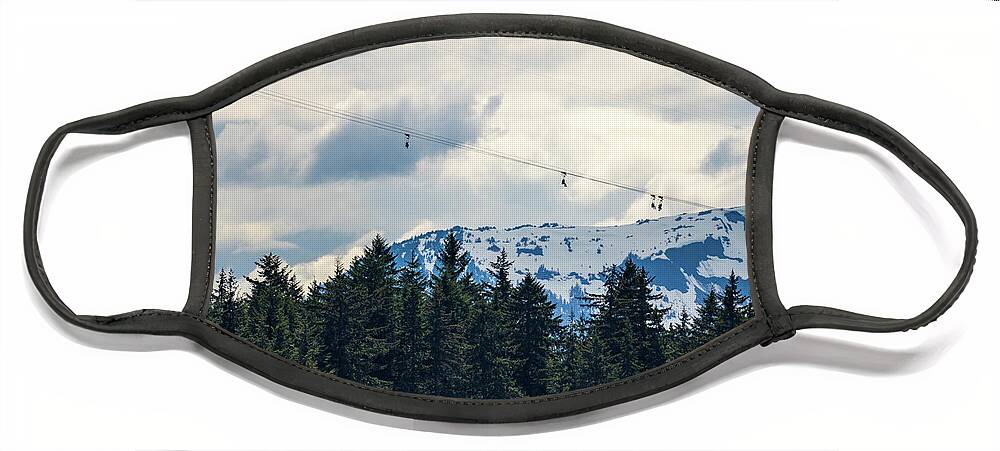 Aerial Face Mask featuring the photograph Tourists in zip line harnesses zoom down the mountain at Icy Str by Steven Heap