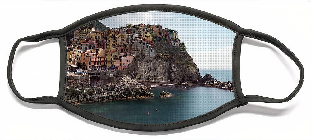 Cinque Terre Face Mask featuring the photograph Village of Manarola with colourful houses at the edge of the cliff Riomaggiore, Cinque Terre, Liguria, Italy by Michalakis Ppalis
