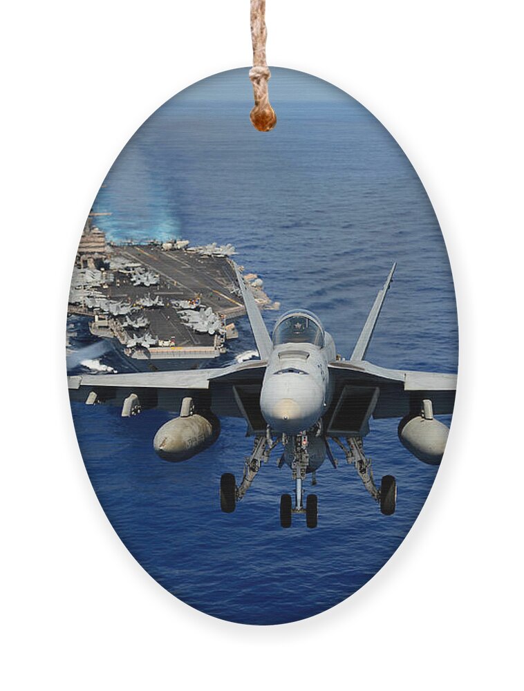 Chinfo Ornament featuring the photograph An F/A-18 Hornet demonstrates air power. by Sebastian Musial