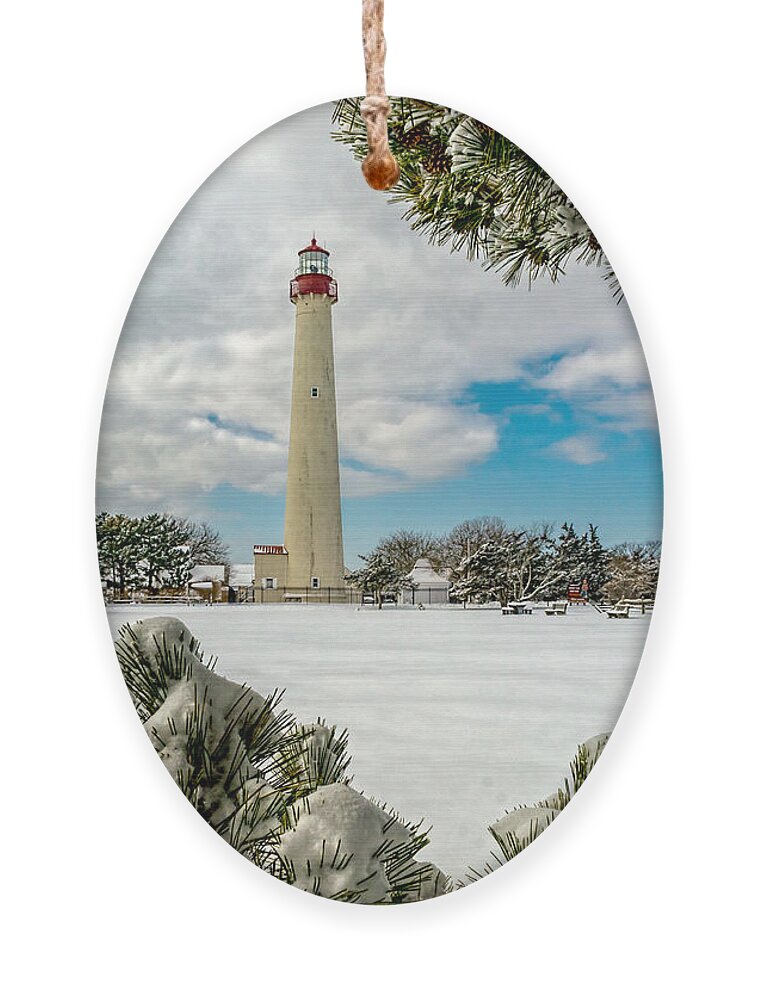 Beacon Ornament featuring the photograph Cape May Light thru Snowy Trees by Nick Zelinsky Jr