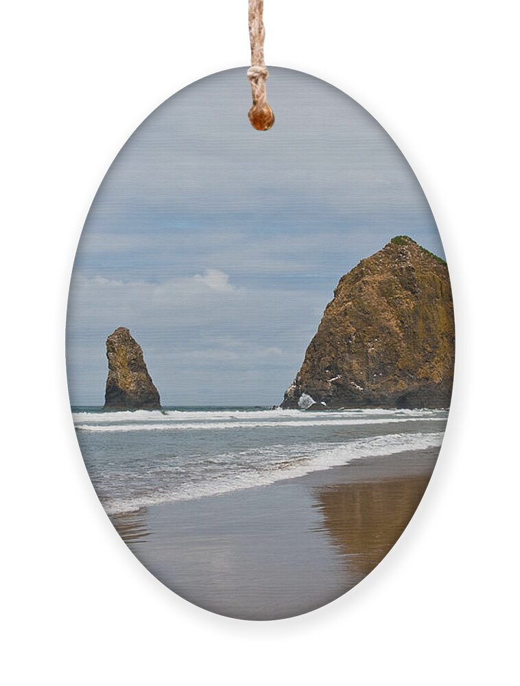 Beach Ornament featuring the photograph Haystack Rock Reflected in the Wet Sand by Jeff Goulden