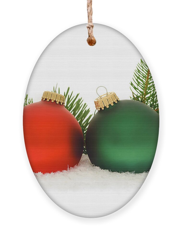 Christmas Ornament featuring the photograph Red and green Christmas baubles by Elena Elisseeva