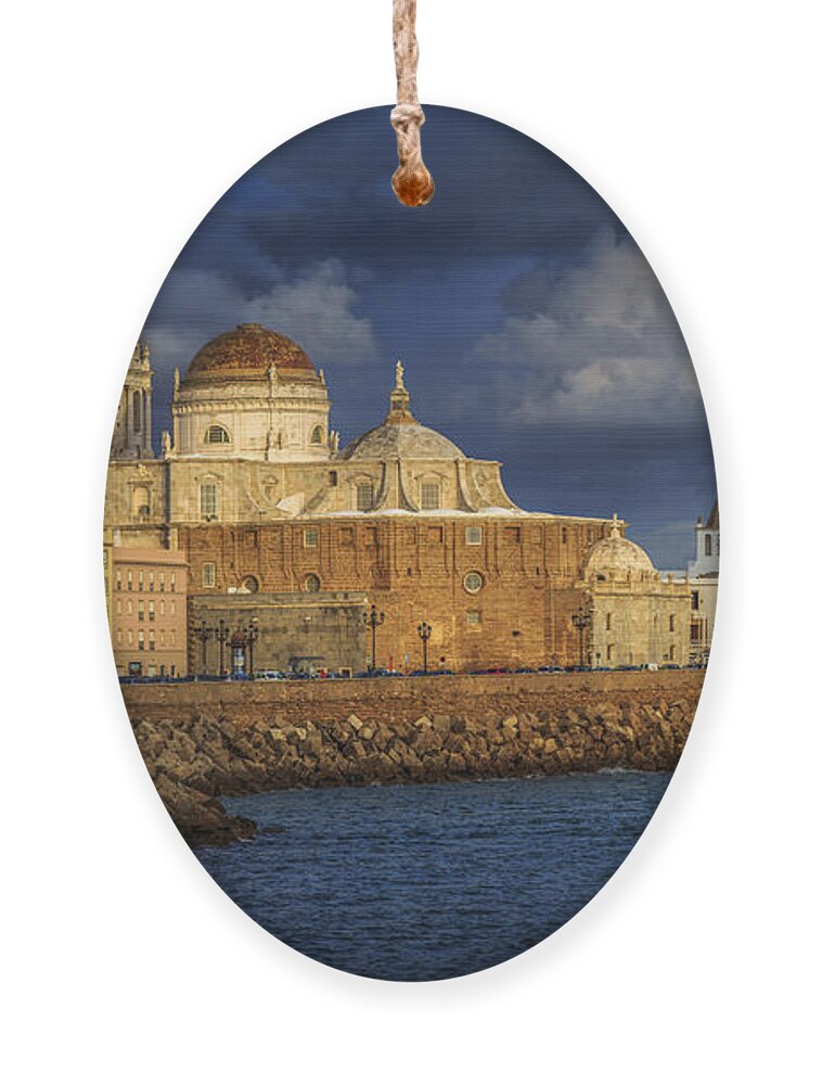 Andalucia Ornament featuring the photograph Stormy Skies Over the Cathedral Cadiz spain by Pablo Avanzini