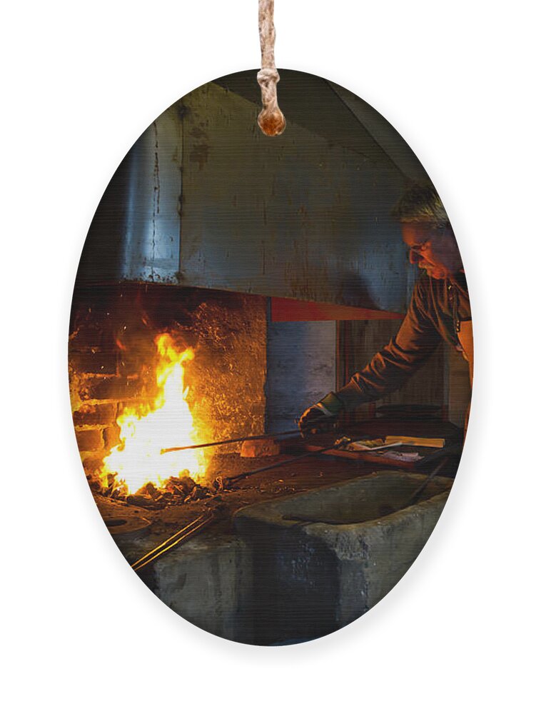 The Torresta Blacksmith Ornament featuring the photograph The Torresta Blacksmith by Torbjorn Swenelius