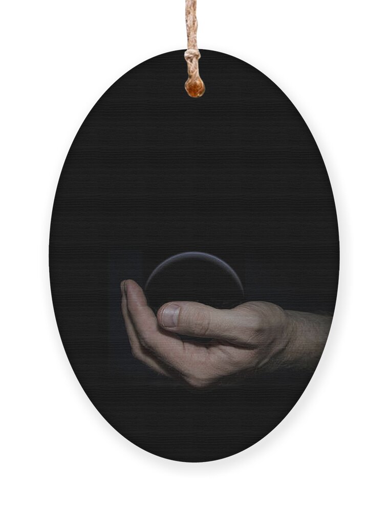 Black Ornament featuring the digital art Black Sphere in Hand by Pelo Blanco Photo