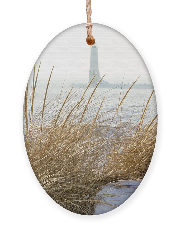 America Ornament featuring the photograph Frankfort North Breakwater Lighthouse through sea grass on dunes by Karen Foley