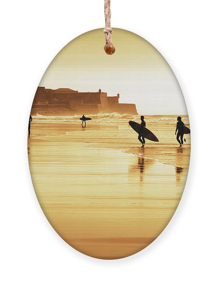 Action Ornament featuring the photograph Surfers silhouettes by Carlos Caetano