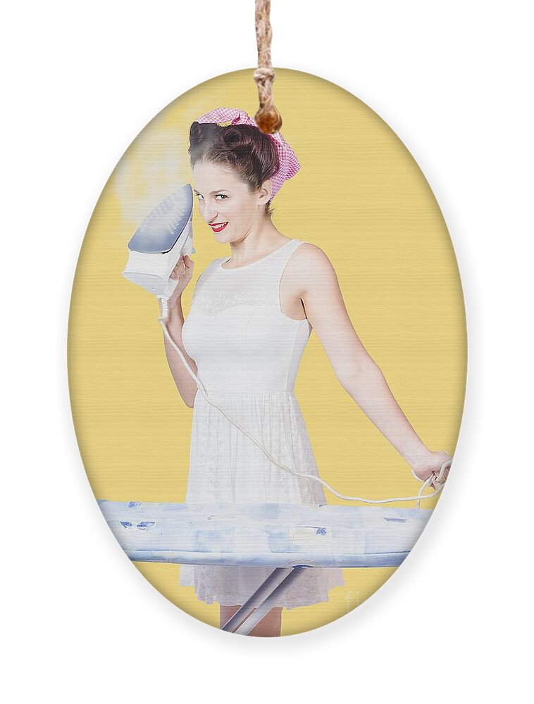 Cleaning Ornament featuring the photograph Pin up woman providing steam clean ironing service by Jorgo Photography
