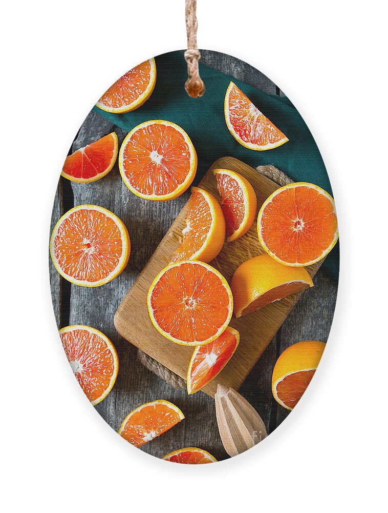 Country Ornament featuring the photograph Red Oranges On Wooden Surface by Diana Taliun