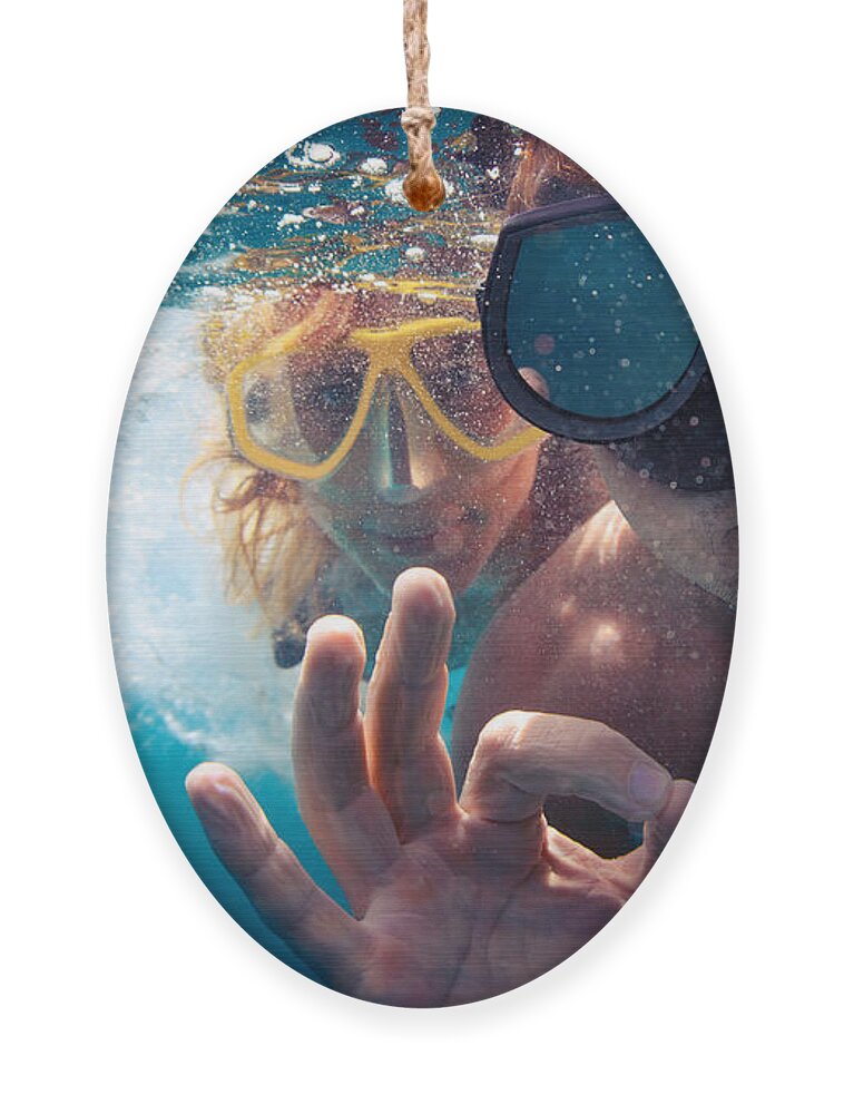 Couple Ornament featuring the photograph Young Couple Having Fun Underwater by Dudarev Mikhail