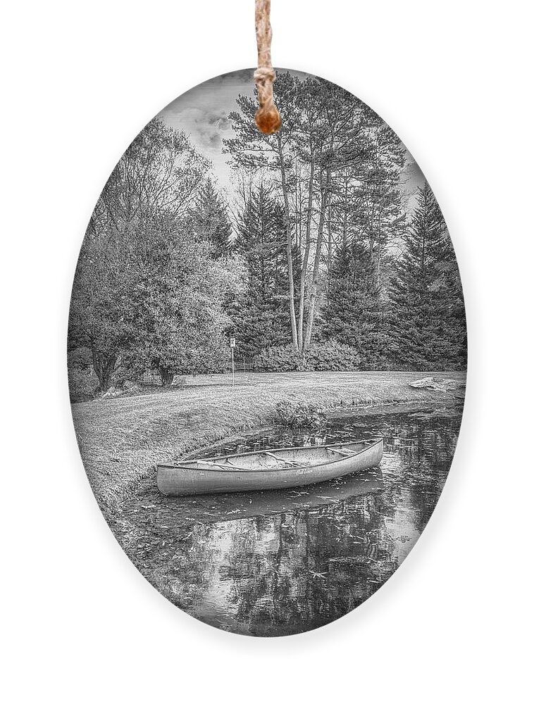 Boats Ornament featuring the photograph Canoe on the Edge of the Lake in Black and White #1 by Debra and Dave Vanderlaan