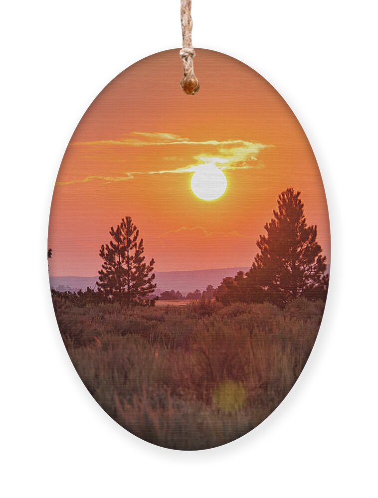 Sunset Ornament featuring the photograph sun setting on the Montana high plateaus #1 by Ann Moore