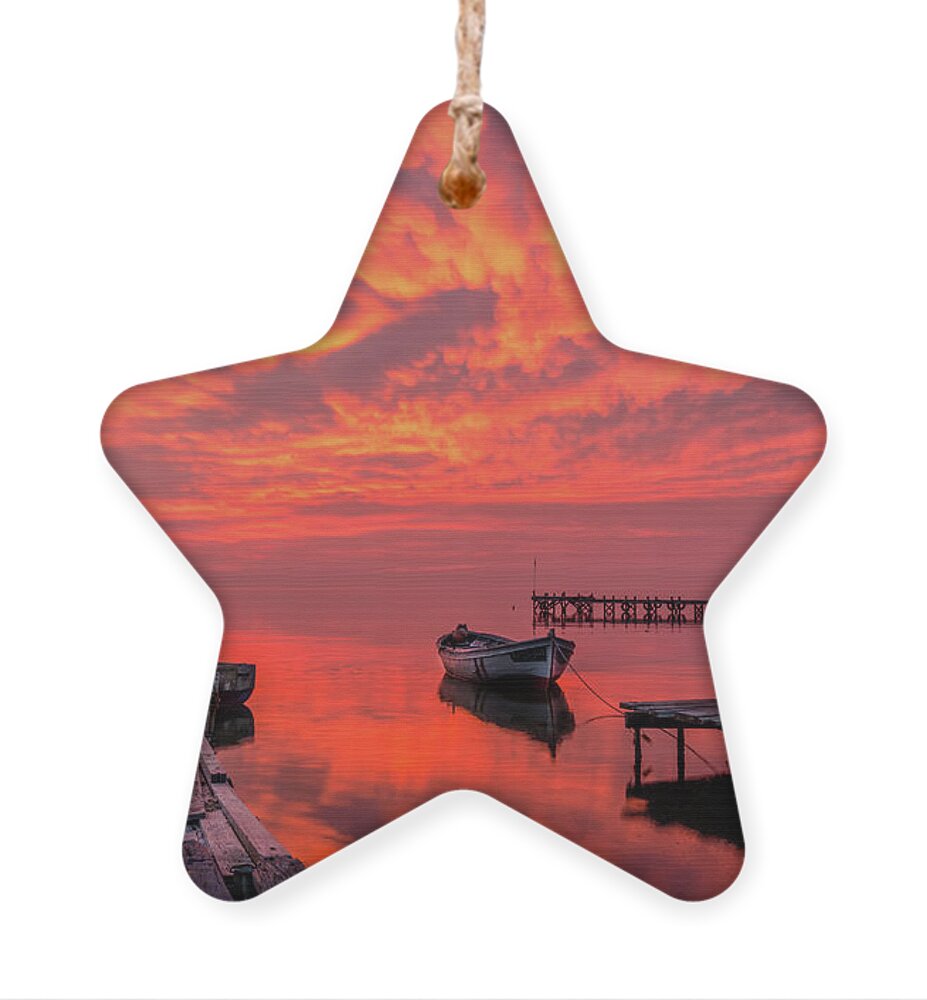 Pier Ornament featuring the photograph A burning sky over an old pier by Alexios Ntounas