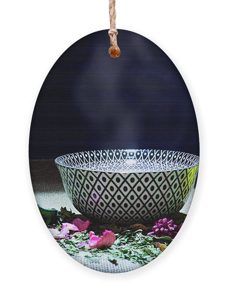 Tea Ornament featuring the photograph A drinking bowl with tea and herbs. by Bernhard Schaffer