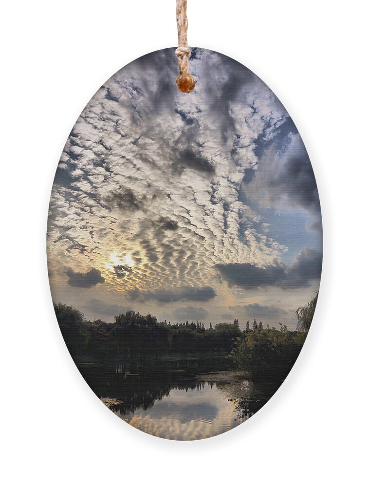 Sunset Ornament featuring the photograph Dramatic clouds at sunset by Delphimages Photo Creations