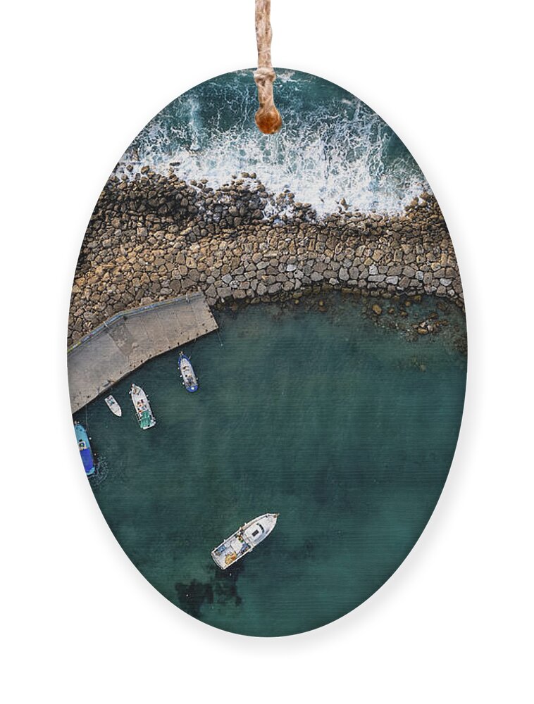 Fishing Harbor Ornament featuring the photograph Drone aerial fishing harbour with boats stormy waves, blue sea by Michalakis Ppalis