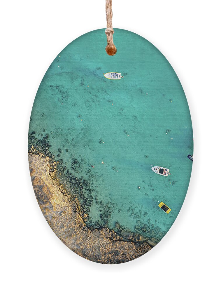 Seascape Ornament featuring the photograph Drone aerial of seascape with idyllic blue calm blue water. Fig tree bay beach Protaras Cyprus by Michalakis Ppalis
