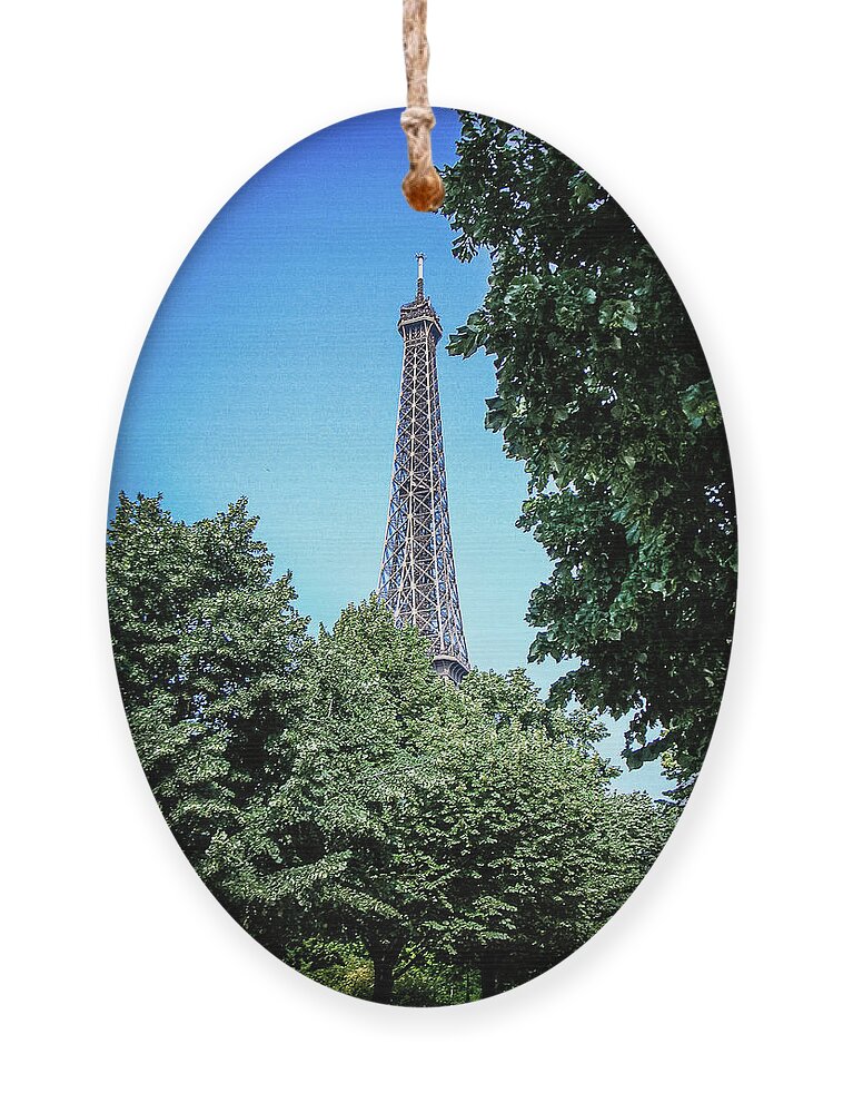 France Ornament featuring the photograph Eiffel Tower through Trees by Jim Feldman
