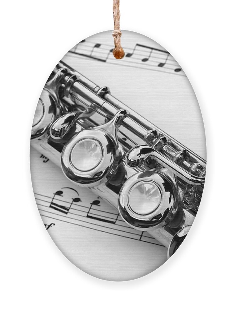 Flute Ornament featuring the photograph Flute and sheet music by Delphimages Photo Creations