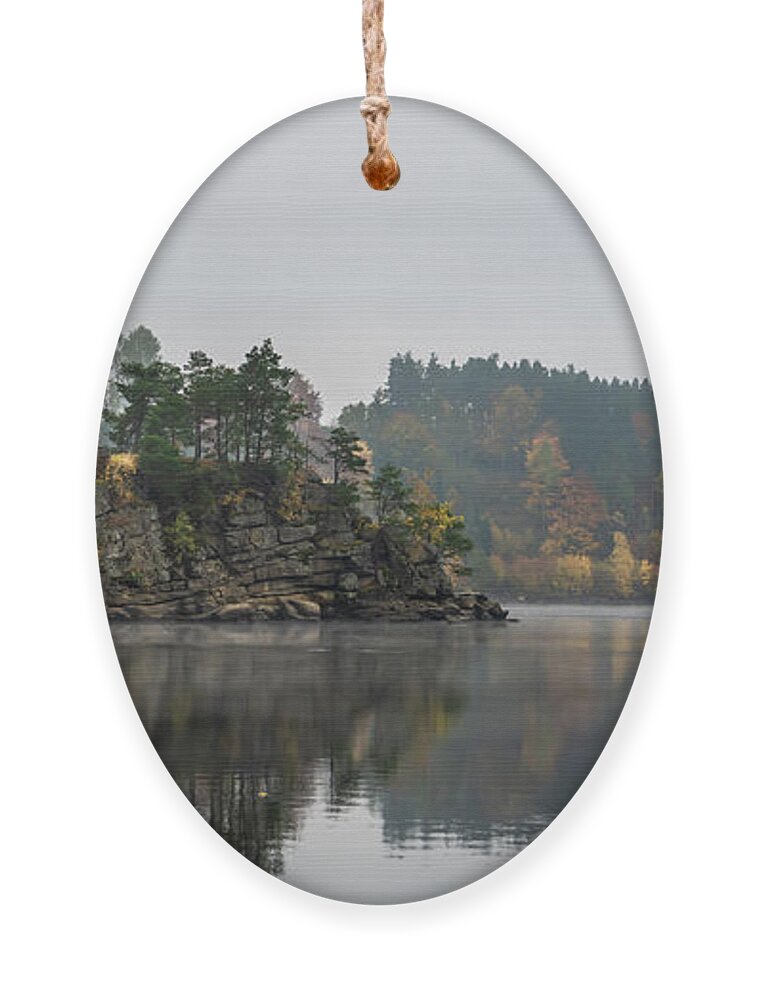 Austria Ornament featuring the photograph Foggy Landscape With Fishermans Boat On Calm Lake And Autumnal Forest At Lake Ottenstein In Austria by Andreas Berthold