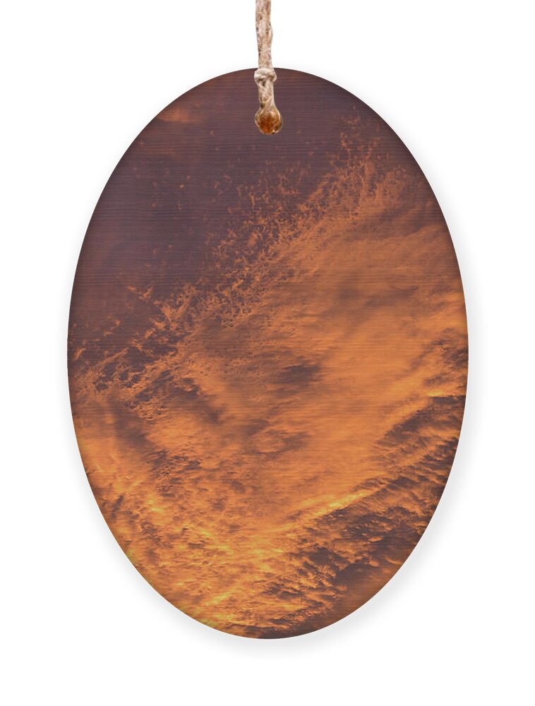 Clouds Ornament featuring the photograph Glowing sunset sky with deep orange clouds by Adriana Mueller